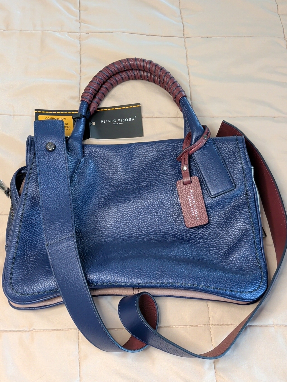 Plinio Visona Navy Leather Bag With Burgundy, Pink, And Gray Accent Leather.